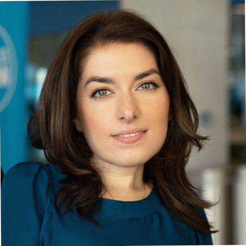 Portrait of Maayan Ziv, Founder and CEO of AccessNow, smiling at the camera.