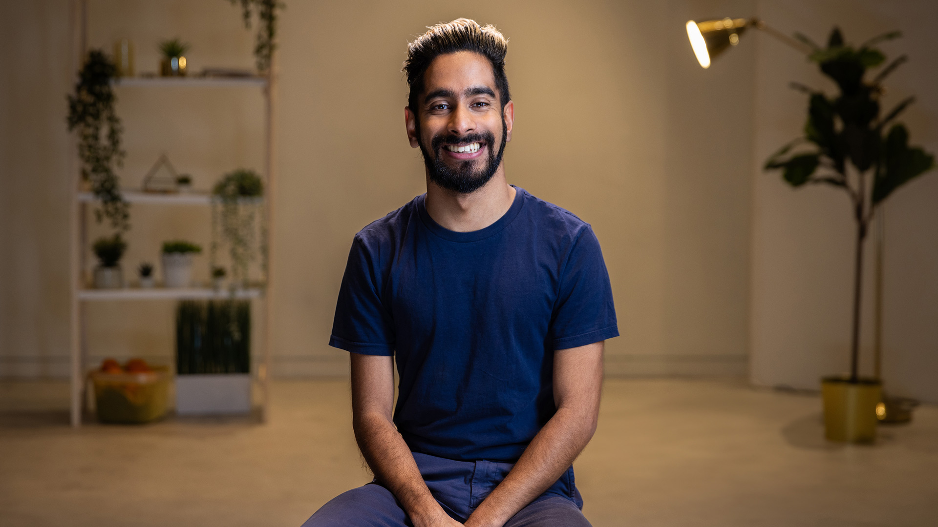 amar smiles as he sits in the access studio