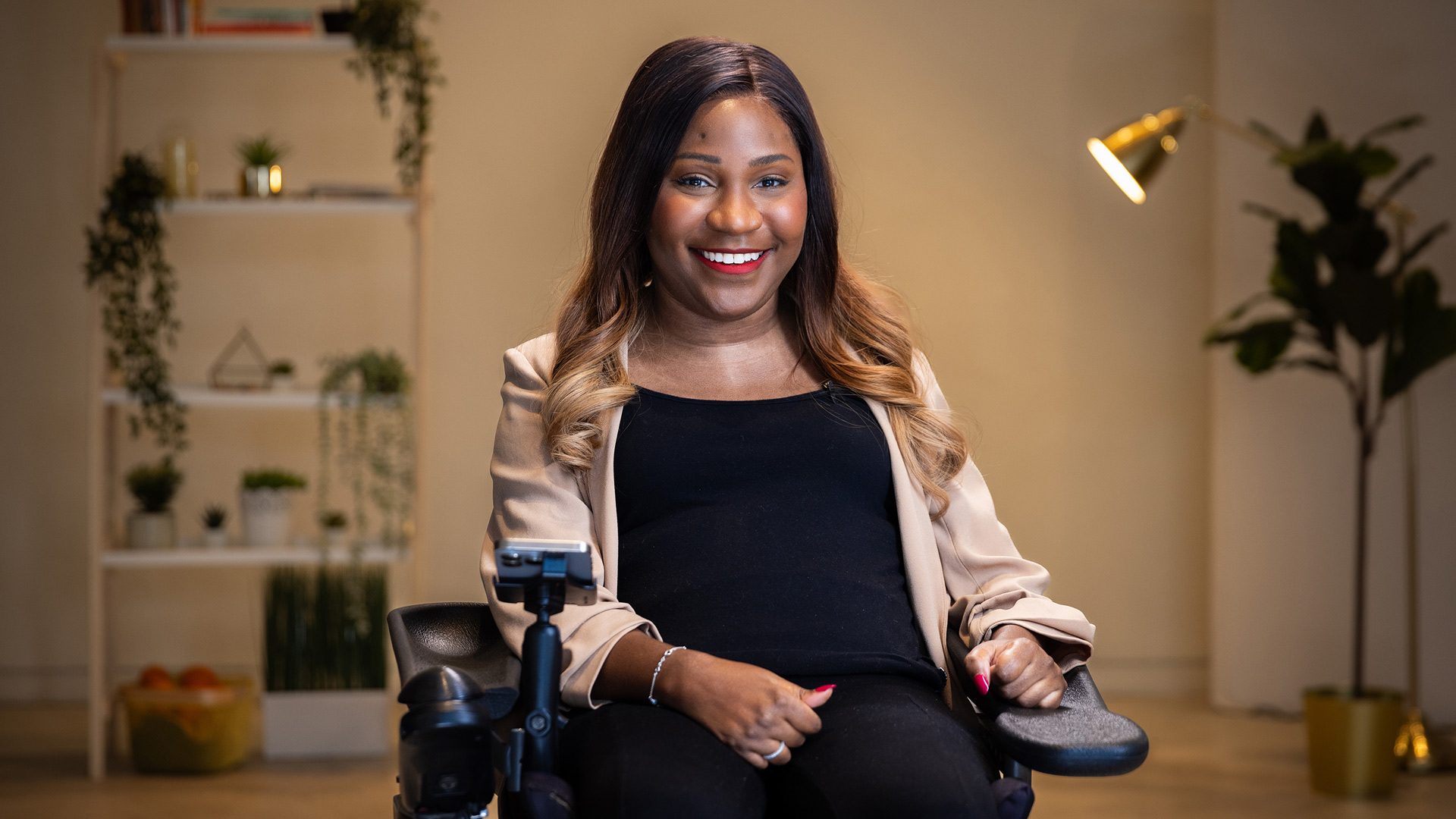 portrait of taylor in her wheelchair smiling in the access studio