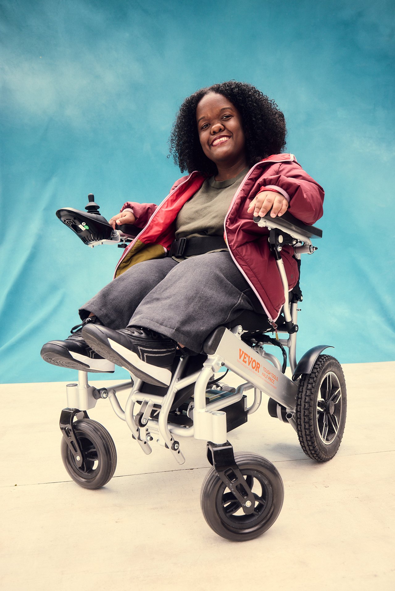 Portrait of Gabi De Leon, disability creator and advocate, smiling at the camera.